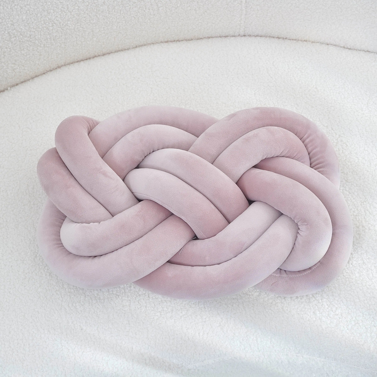 Decorative cushion with a knot pattern