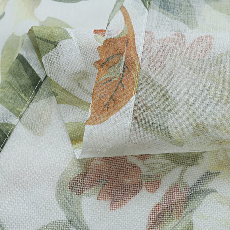 Sheer curtain with a floral pattern