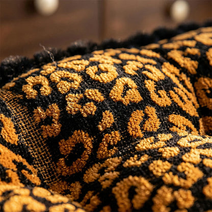 Coussin à motif léopard avec pompons