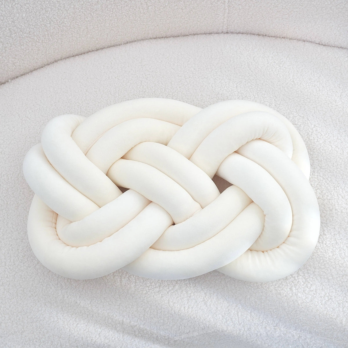 Decorative cushion with a knot pattern