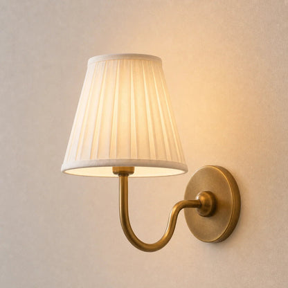 Wall lamp with a pleated shade