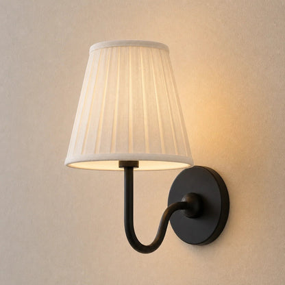 Wall lamp with a pleated shade