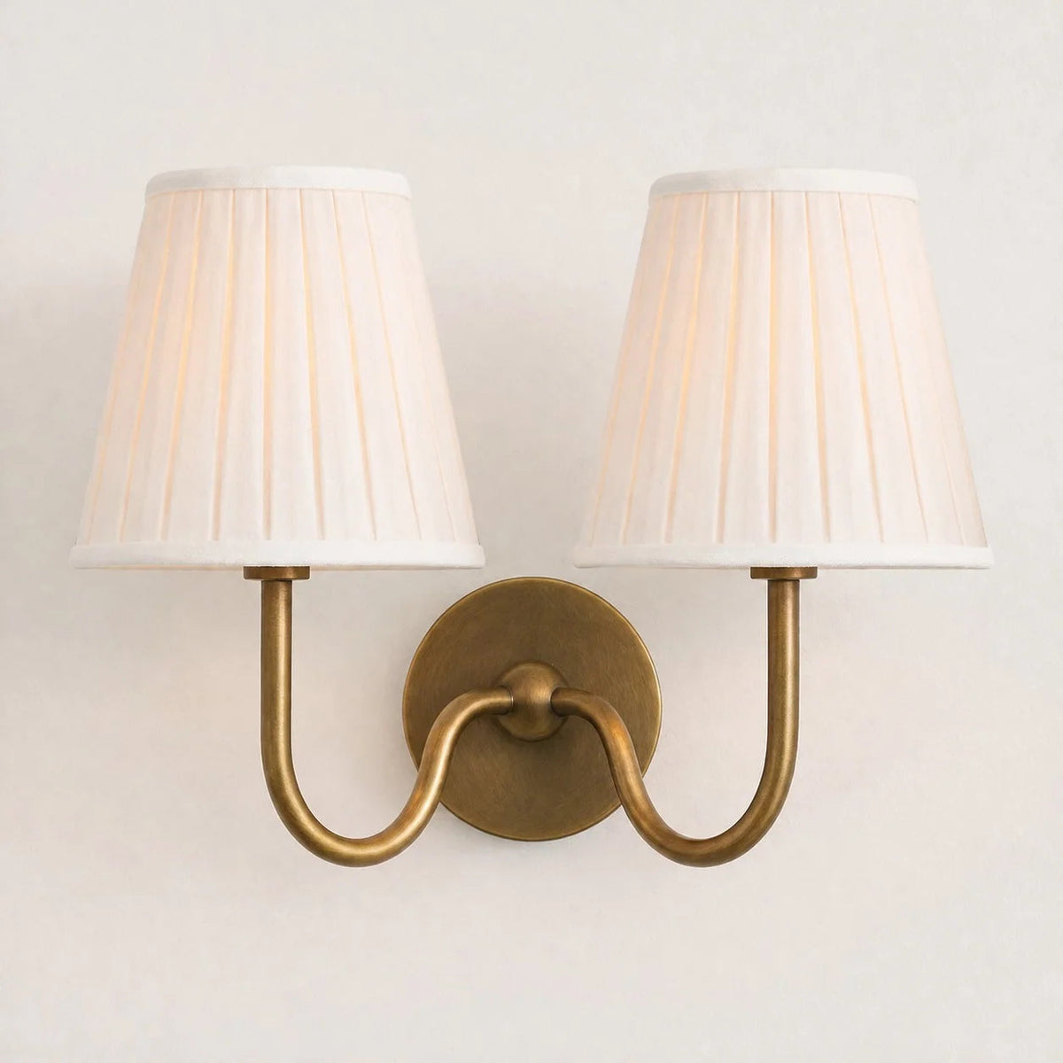 Wall lamp with a pleated shade