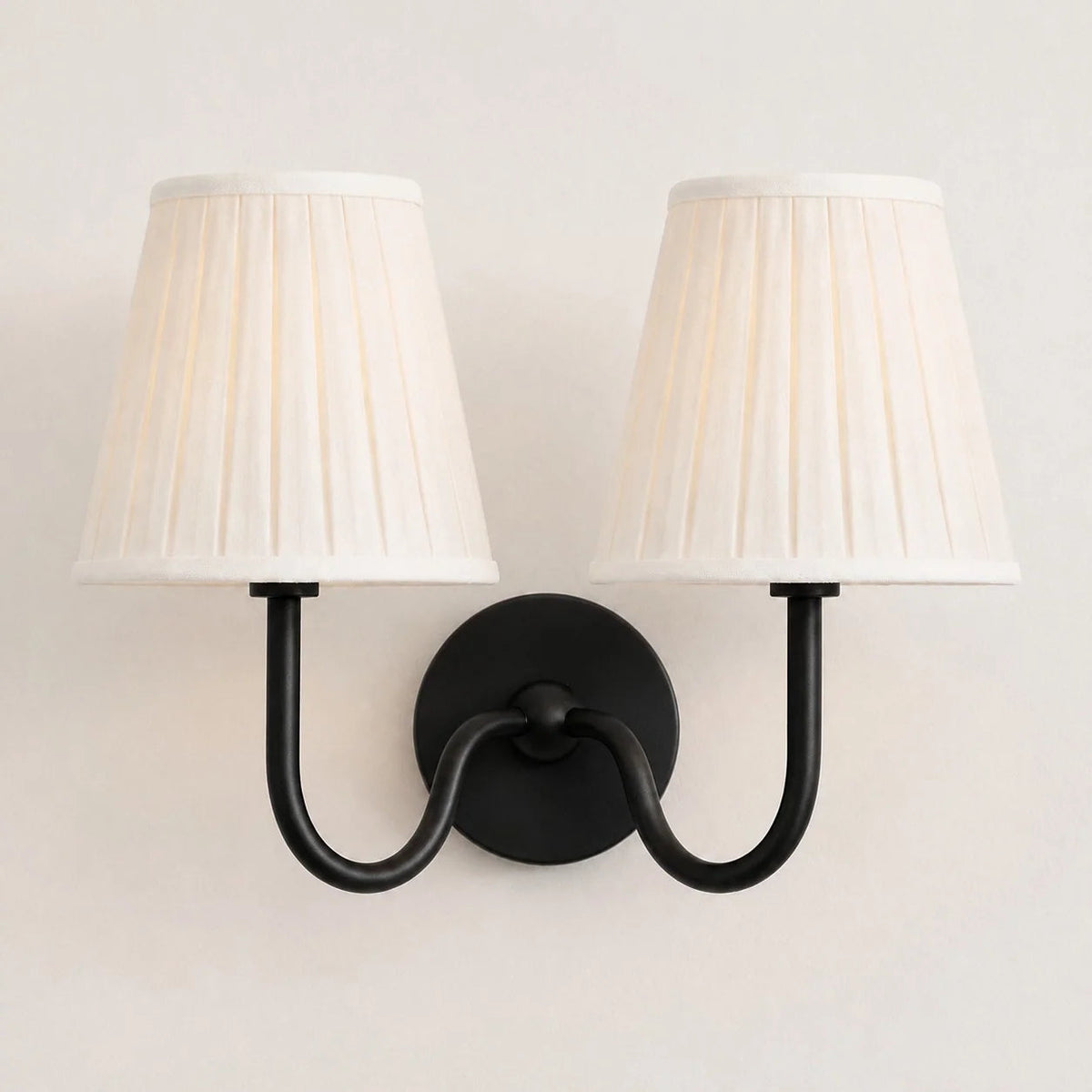 Wall lamp with a pleated shade