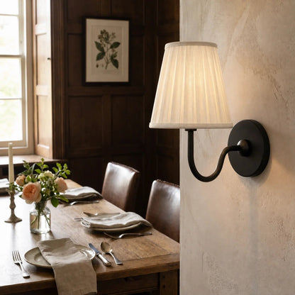 Wall lamp with a pleated shade